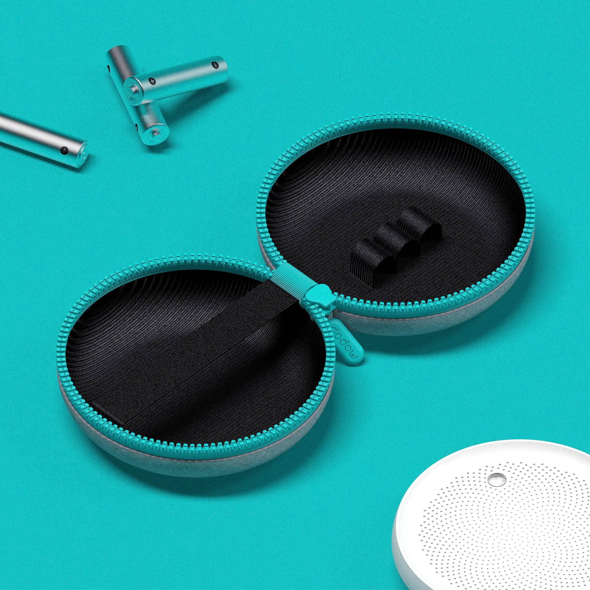 Open turquoise travel case with black interior for sleep aid device, batteries, and white gadget on blue background.